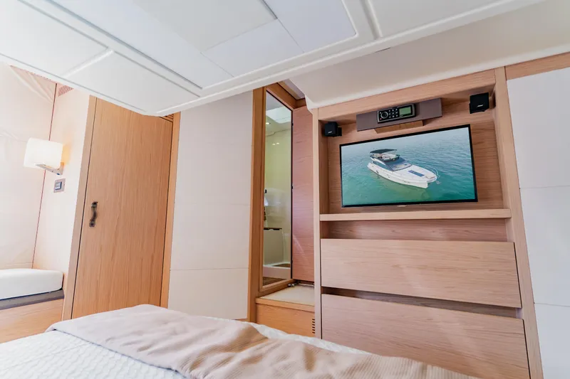 Slide: The Image of Luxurious Monte Carlo MC5 2015 yacht interior with TV and modern wood finish. - 41