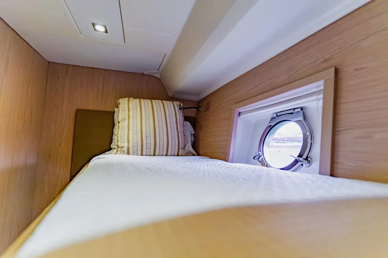 Slide: The Image of Cozy cabin interior of 2015 Monte Carlo MC5 yacht with porthole and bed. - 52