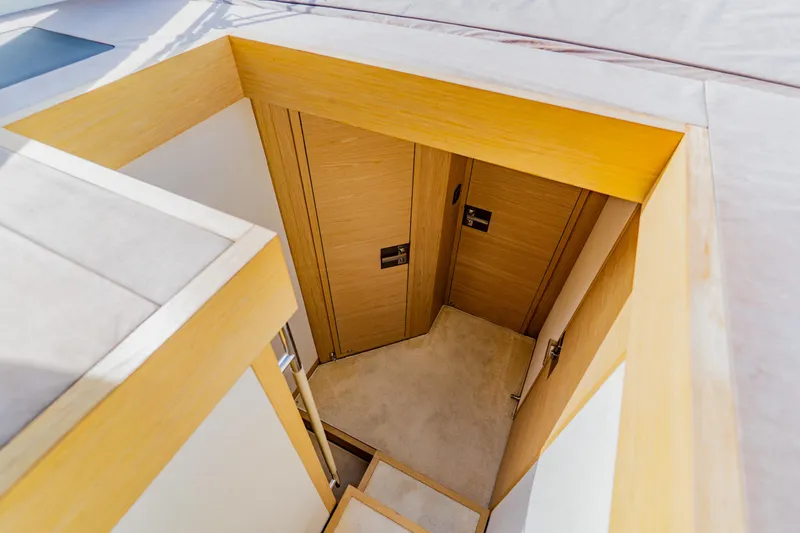 Slide: The Image of Staircase leading to wooden doors inside 2015 Monte Carlo MC5 yacht. - 57