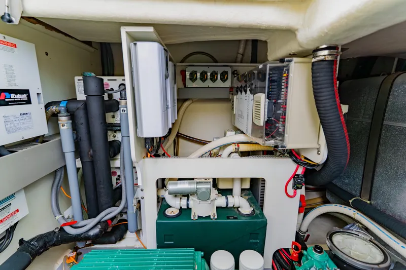 Slide: The Image of Engine room of 2015 Monte Carlo MC5 yacht, showcasing complex mechanical systems and wiring. - 65