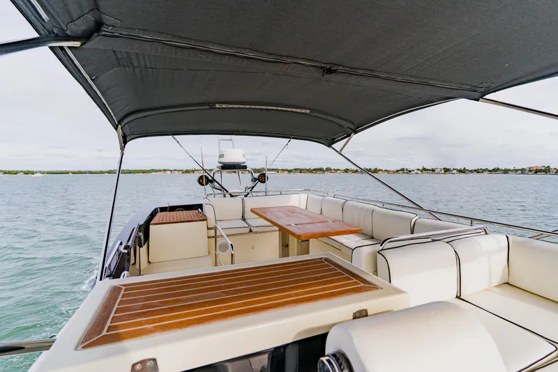 Slide: The Image of Luxurious 2015 Monte Carlo MC5 yacht interior with elegant seating and wooden tables. - 73