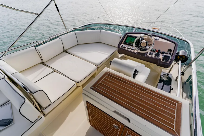 Slide: The Image of Luxurious 2015 Monte Carlo MC5 yacht cockpit with plush seating and modern controls. - 74