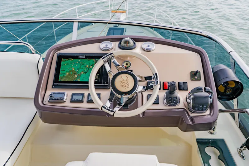 Slide: The Image of Helm of 2015 Monte Carlo MC5 yacht with navigation controls and steering wheel. - 77