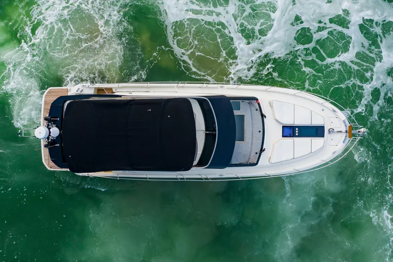 Slide: The Image of Overhead view of 2015 Monte Carlo MC5 yacht navigating through green ocean waters. - 84