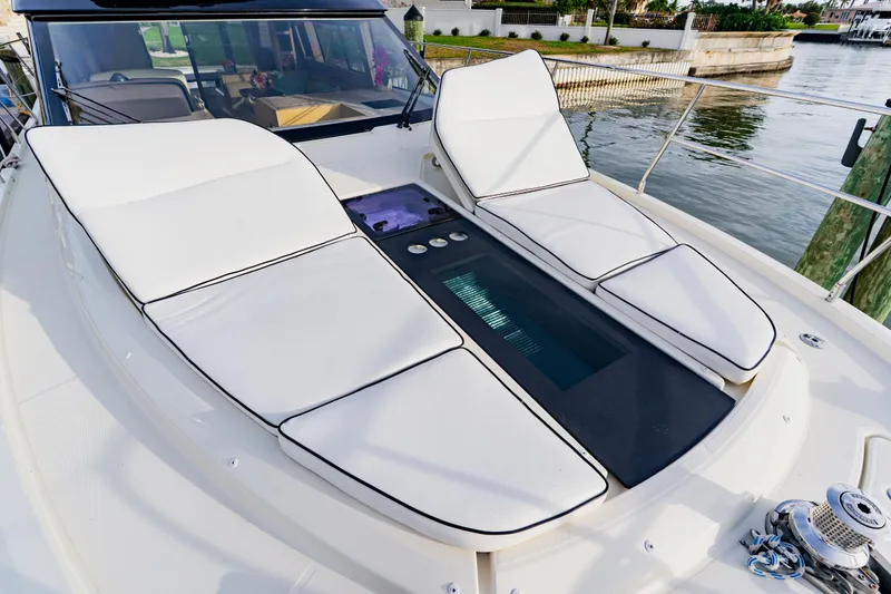Slide: The Image of Luxurious 2015 Monte Carlo MC5 yacht with white sun loungers on deck. - 12