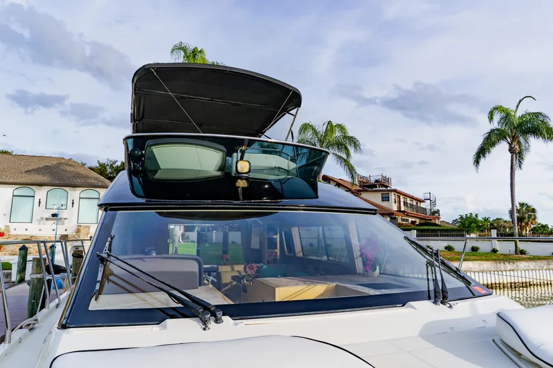 Slide: The Image of 2015 Monte Carlo MC5 yacht docked, featuring sleek design and spacious interior. - 13