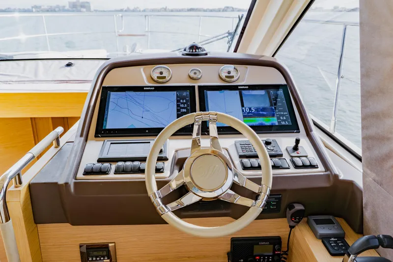 Slide: The Image of Steering console of 2015 Monte Carlo MC5 yacht with navigation screens and controls. - 21