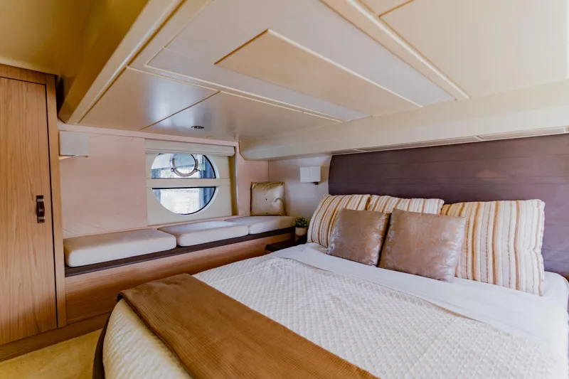 Slide: The Image of Luxurious 2015 Monte Carlo MC5 yacht bedroom with elegant decor and round window. - 31