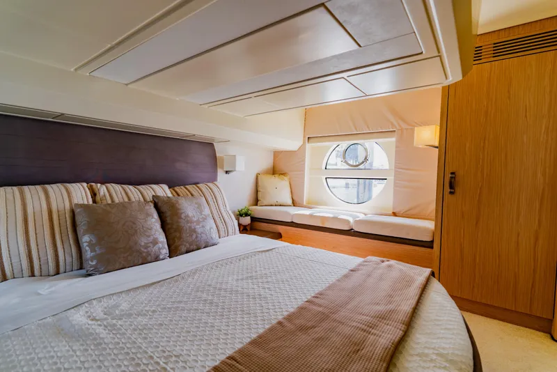 Slide: The Image of Luxurious 2015 Monte Carlo MC5 yacht bedroom with elegant decor and circular window. - 32