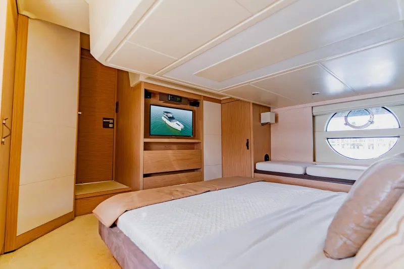 Slide: The Image of Luxurious 2015 Monte Carlo MC5 yacht bedroom with modern decor and circular window. - 35