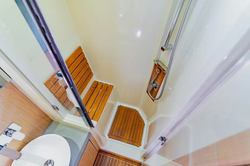 Slide: The Image of Luxurious shower area in 2015 Monte Carlo MC5 yacht with wooden seating and modern fixtures. - 39