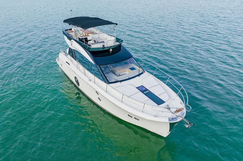 Slide: The Image of Luxury Monte Carlo MC5 yacht from 2015 on serene blue waters. - 4