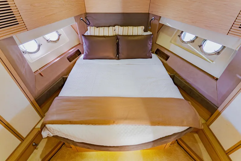 Slide: The Image of Luxurious cabin interior of 2015 Monte Carlo MC5 yacht with cozy bed and porthole windows. - 46