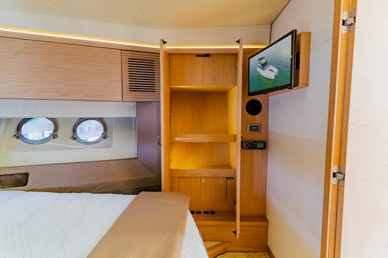 Slide: The Image of Luxurious Monte Carlo MC5 2015 yacht interior with wooden cabinetry and porthole windows. - 48