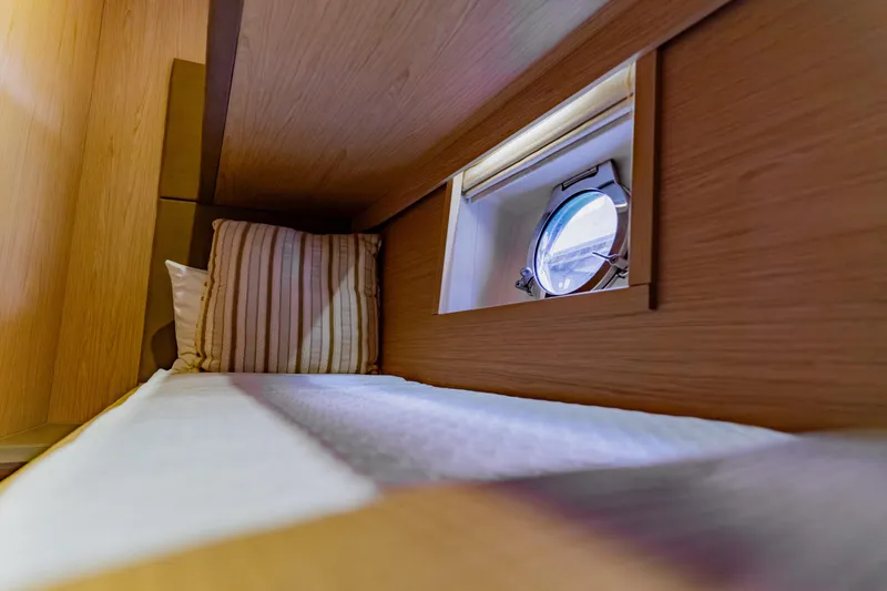 Slide: The Image of Cozy cabin interior of 2015 Monte Carlo MC5 yacht with porthole and striped pillow. - 53