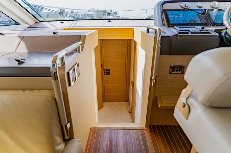 Slide: The Image of Interior of 2015 Monte Carlo MC5 yacht, featuring helm and cabin entrance. - 58