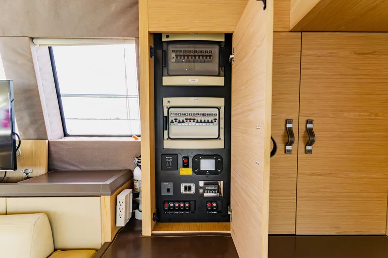 Slide: The Image of Electrical panel inside 2015 Monte Carlo MC5 yacht, featuring modern wooden cabinetry. - 59