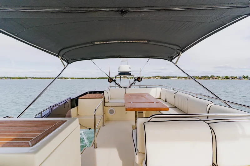 Slide: The Image of Luxurious 2015 Monte Carlo MC5 yacht interior with spacious seating and table on open water. - 72