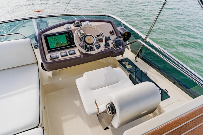 Slide: The Image of Cockpit of 2015 Monte Carlo MC5 yacht with navigation controls and steering wheel. - 75
