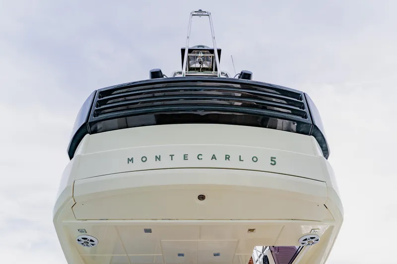 Slide: The Image of Monte Carlo MC5 yacht, 2015 model, rear view against a cloudy sky. - 82