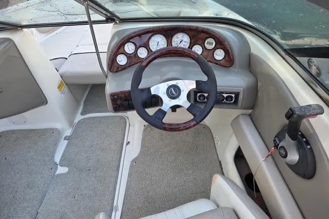 Slide: The Image of 2005 Caravelle 207 Bow Rider boat interior with steering wheel and dashboard controls. - 3