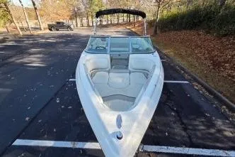 Slide: The Image of 2005 Caravelle 207 Bow Rider boat parked in a lot, front view. - 4