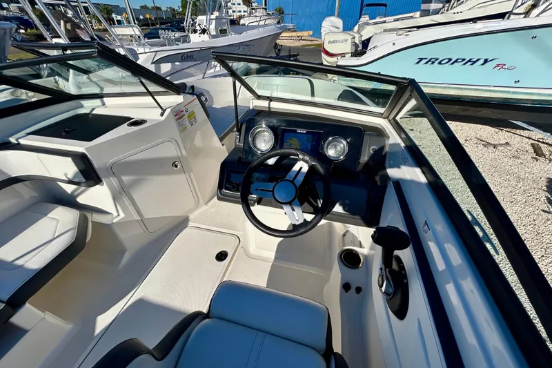 Slide: The Image of 2018 Sea Ray SPX 190 Outboard boat interior with steering wheel and dashboard controls. - 10