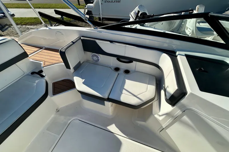 Slide: The Image of 2018 Sea Ray SPX 190 Outboard boat interior with white seating and cup holders. - 12