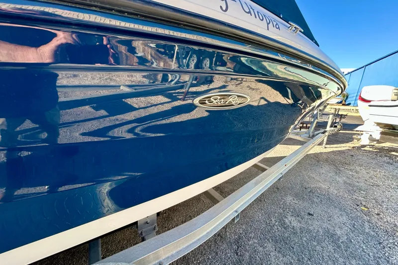 Slide: The Image of 2018 Sea Ray SPX 190 Outboard boat on trailer, glossy blue finish. - 2