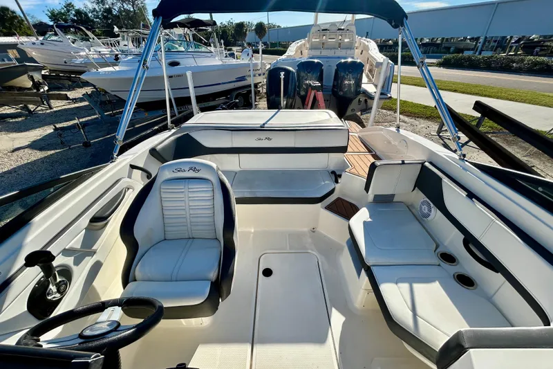 Slide: The Image of 2018 Sea Ray SPX 190 Outboard boat interior with seating and steering wheel. - 6