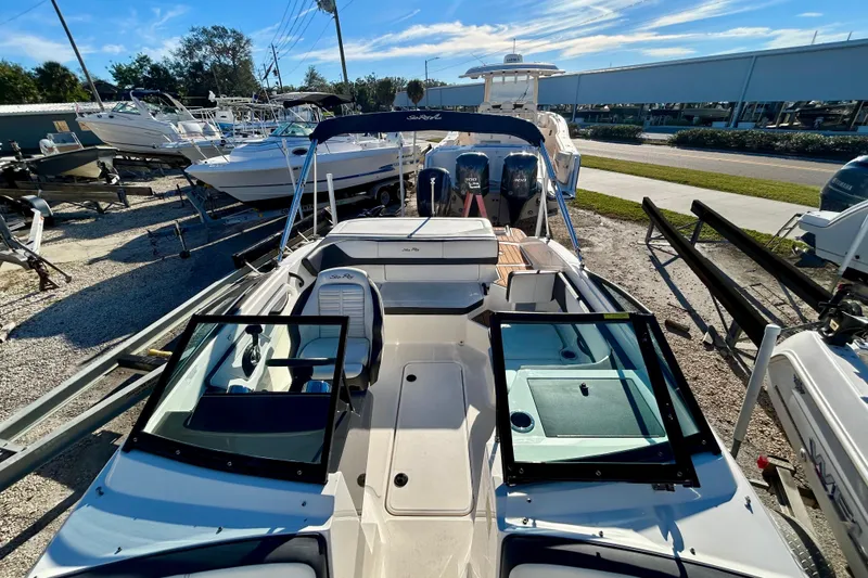 Slide: The Image of 2018 Sea Ray SPX 190 Outboard boat in a marina, surrounded by other vessels. - 7