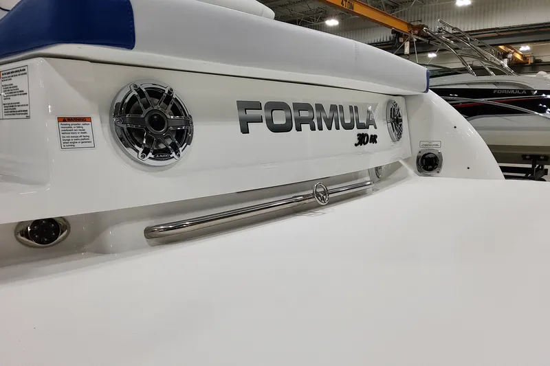 Slide: The Image of 2026 Formula 310 Bowrider I/O boat rear view with speakers and branding. - 10
