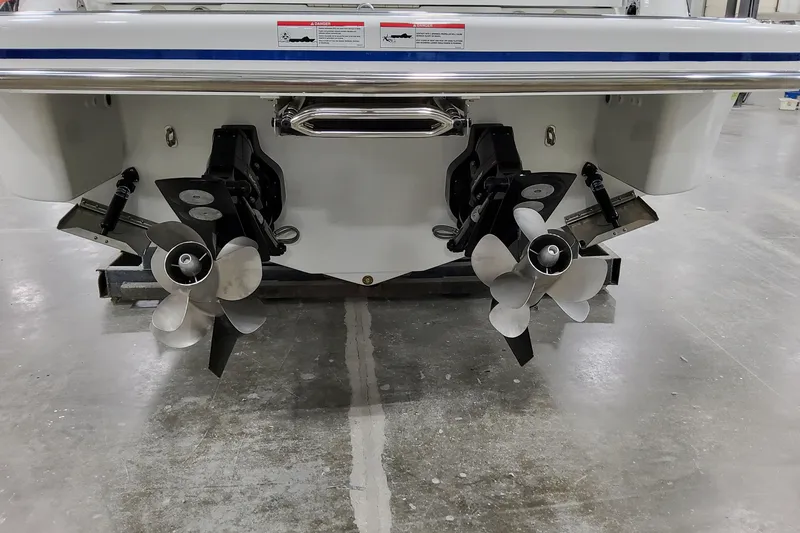 Slide: The Image of Rear view of 2026 Formula 310 Bowrider I/O with dual propellers in a showroom. - 14