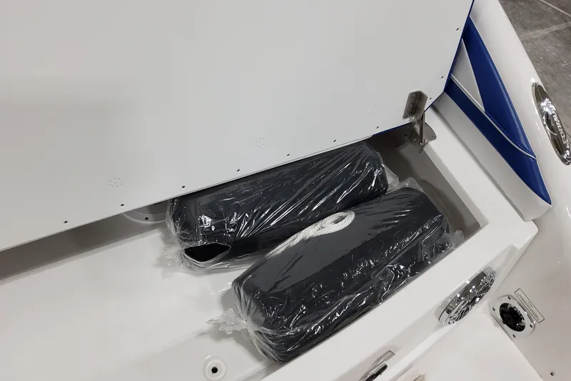 Slide: The Image of Storage compartment of 2026 Formula 310 Bowrider I/O with packaged accessories. - 18