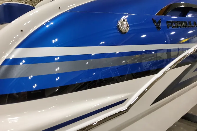 Slide: The Image of 2026 Formula 310 Bowrider I/O boat with sleek blue and white design. - 2