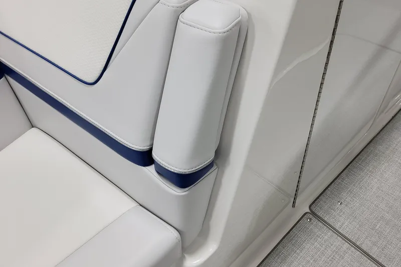 Slide: The Image of 2026 Formula 310 Bowrider I/O interior seating detail with white and blue upholstery. - 21