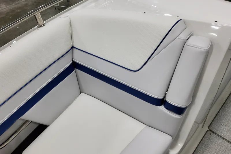 Slide: The Image of 2026 Formula 310 Bowrider I/O boat interior with white and blue cushioned seating. - 22
