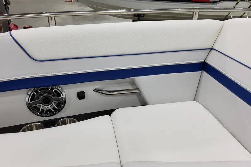 Slide: The Image of 2026 Formula 310 Bowrider I/O interior with white and blue seating, speaker, and cup holders. - 23
