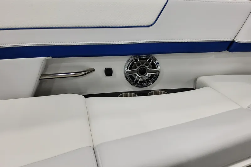 Slide: The Image of 2026 Formula 310 Bowrider I/O interior with speaker, cup holders, and white-blue seating. - 27