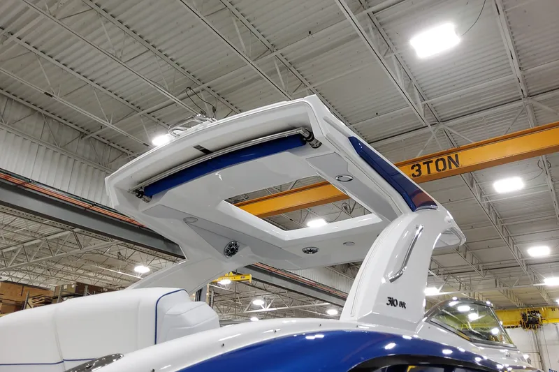 Slide: The Image of 2026 Formula 310 Bowrider I/O boat in a warehouse, showcasing sleek design and modern features. - 3