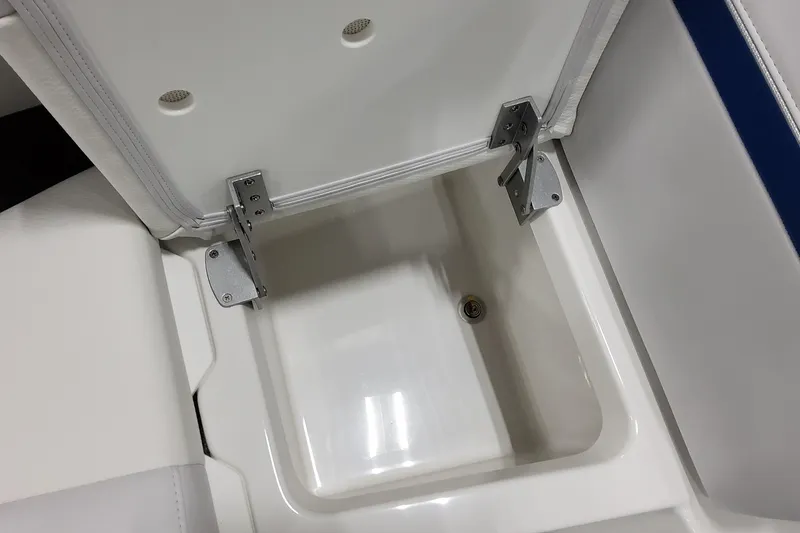 Slide: The Image of 2026 Formula 310 Bowrider I/O storage compartment with open lid and metal hinges. - 30