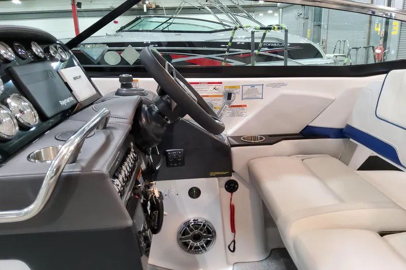 Slide: The Image of 2026 Formula 310 Bowrider I/O cockpit with modern controls and luxurious seating. - 42
