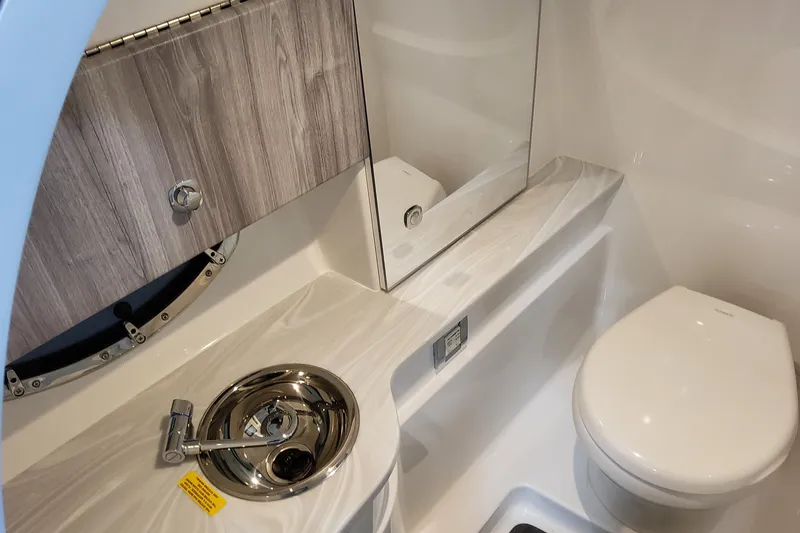 Slide: The Image of 2026 Formula 310 Bowrider I/O boat bathroom with modern sink and toilet. - 45