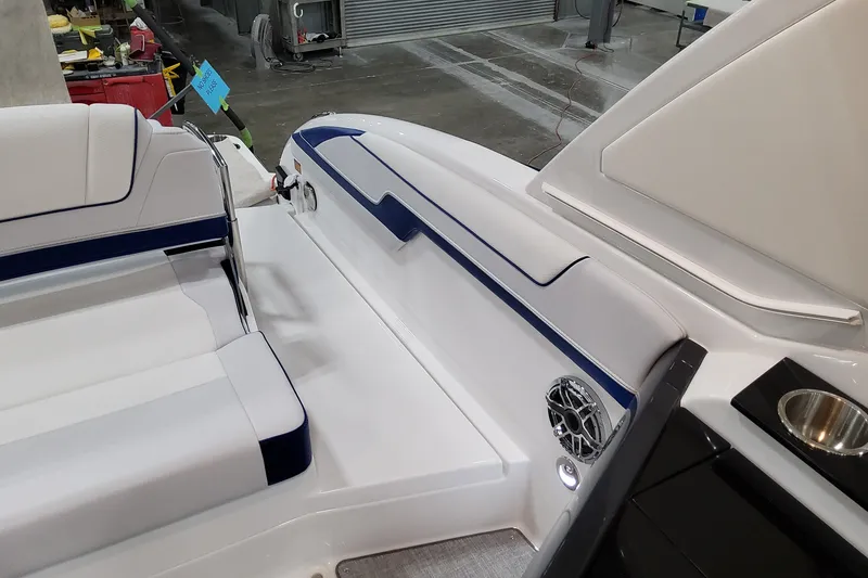 Slide: The Image of 2026 Formula 310 Bowrider I/O interior with white seating and blue accents. - 53