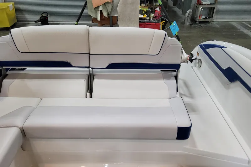 Slide: The Image of 2026 Formula 310 Bowrider I/O boat interior with white and blue seating. - 54