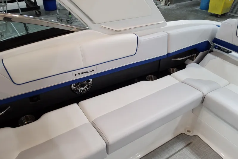 Slide: The Image of 2026 Formula 310 Bowrider I/O boat interior with white seating and speaker system. - 56
