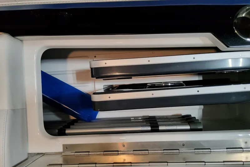 Slide: The Image of Storage compartment in 2026 Formula 310 Bowrider I/O boat, featuring neatly stacked equipment. - 60