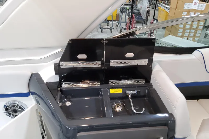 Slide: The Image of 2026 Formula 310 Bowrider I/O boat interior with sink and storage compartments. - 62