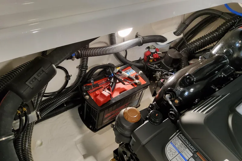 Slide: The Image of Engine compartment of 2026 Formula 310 Bowrider I/O with battery and wiring. - 67