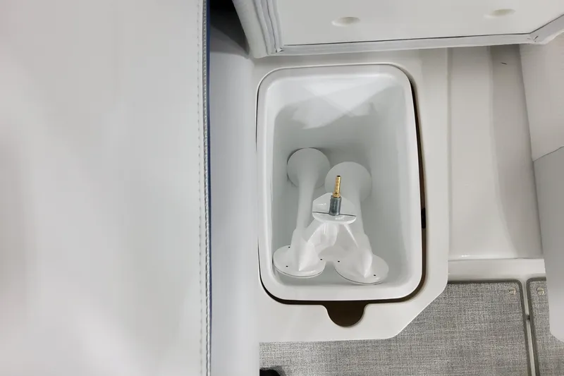 Slide: The Image of 2026 Formula 310 Bowrider I/O boat interior storage compartment with white plastic fittings. - 69